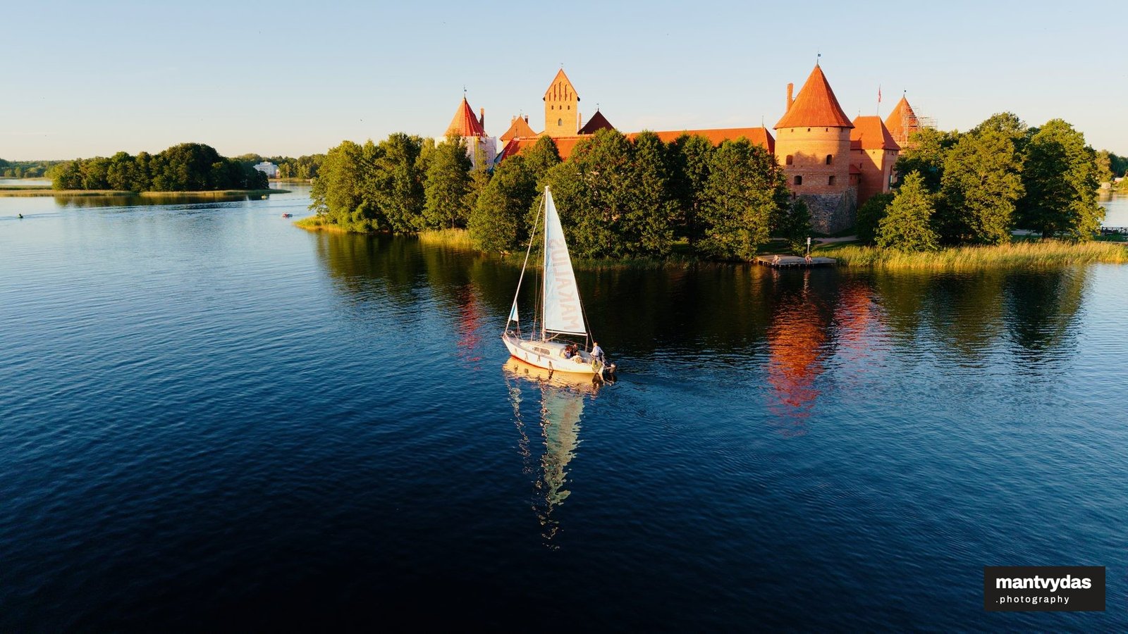 Sailboat at Trakai Island Castle, summer golden hour