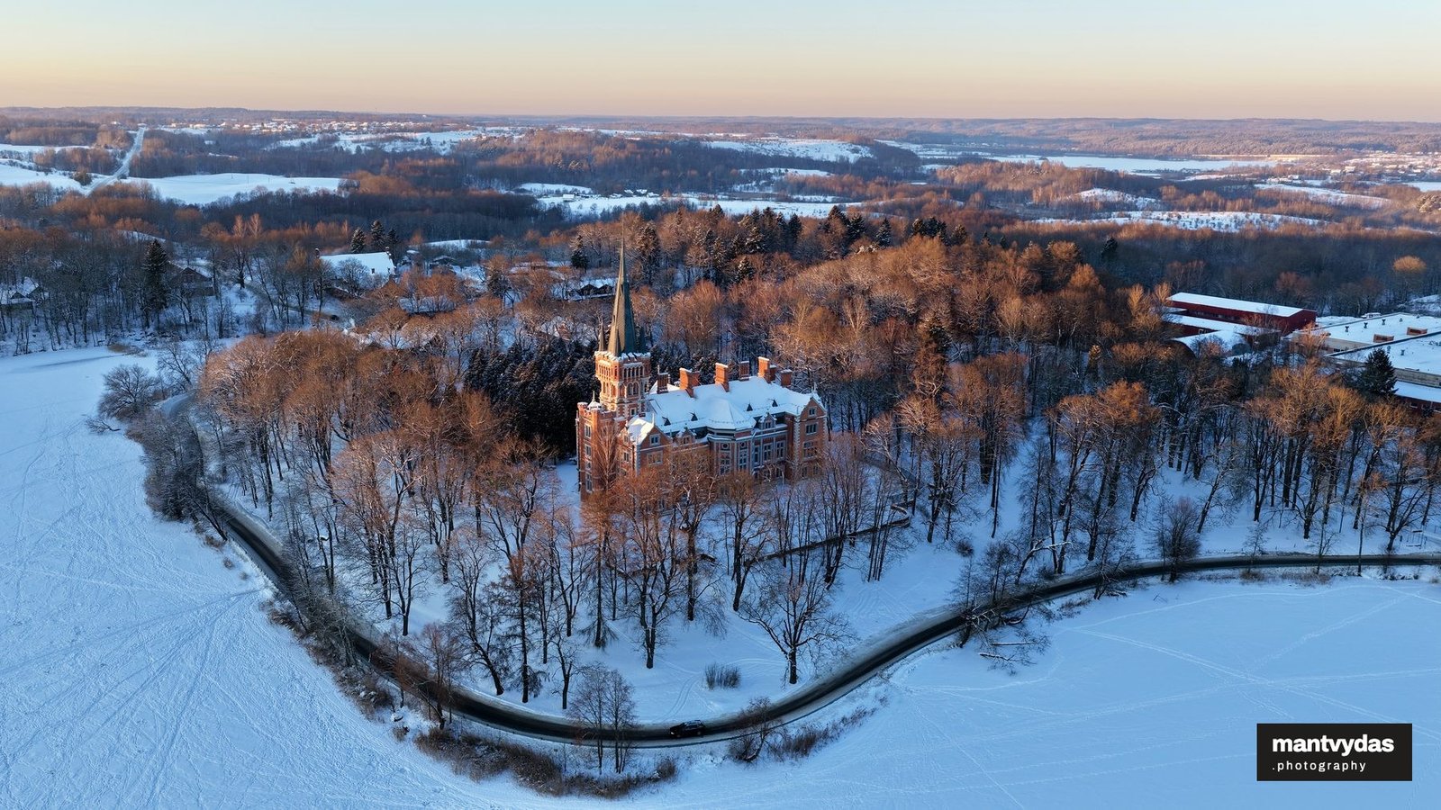 Lentvaris Manor and frozen lake, winter golden hour